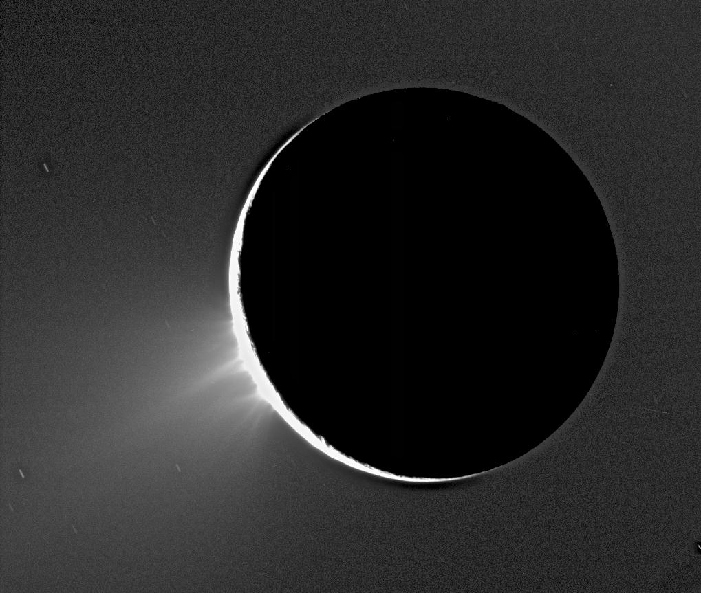 Backlit jets of icy spray rising above the south polar limb of Enceladus