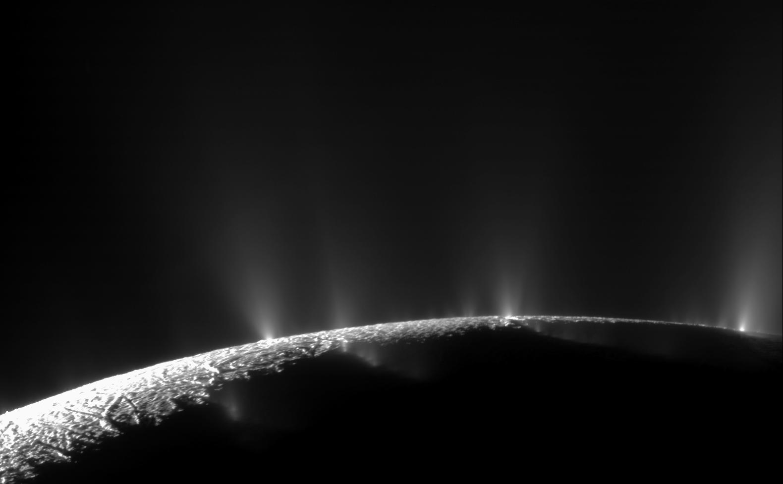Many plumes of water ice and vapor spraying from the tiger stripe fractures near the south pole of Enceladus