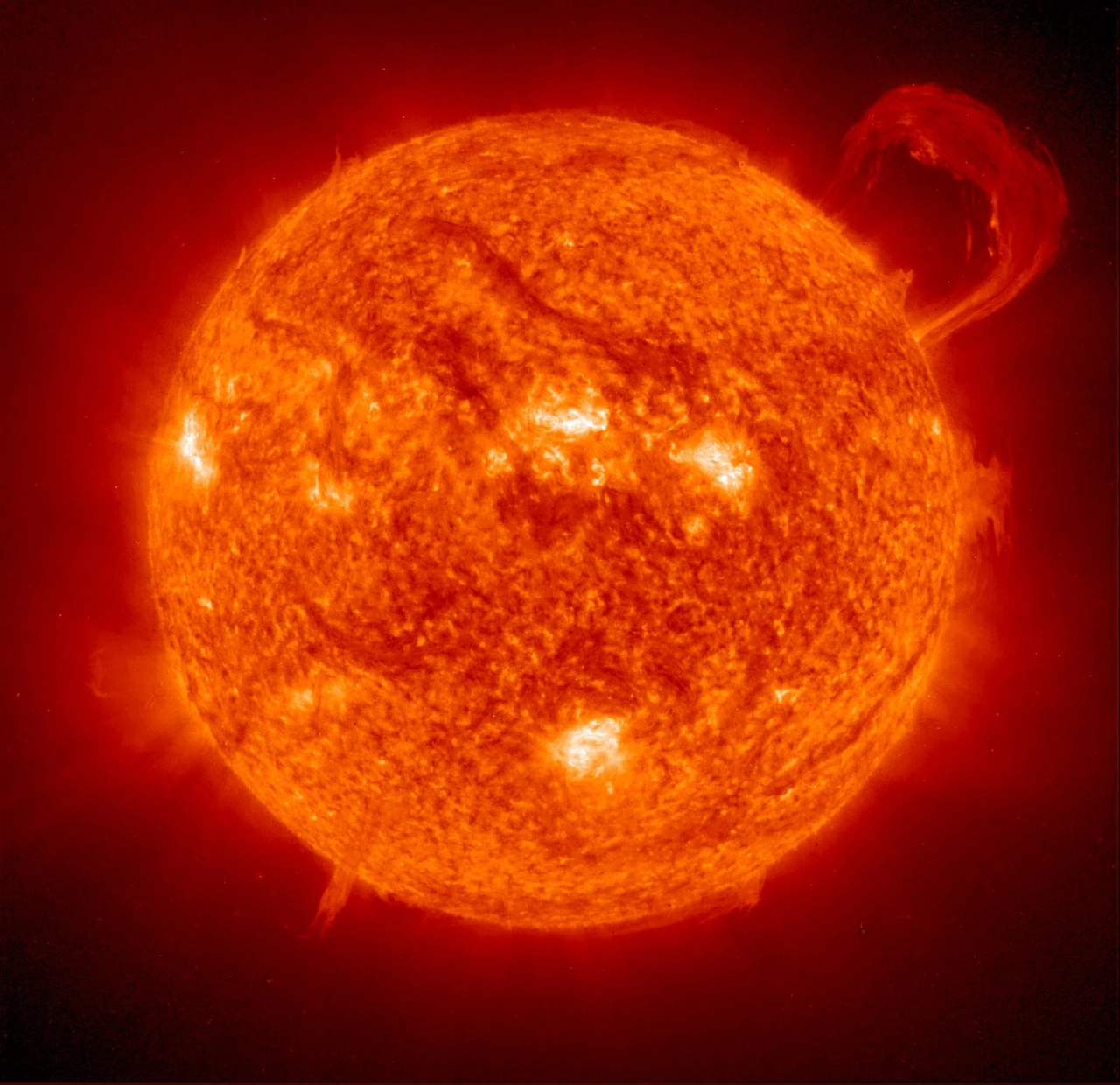 The Sun in extreme ultraviolet light from SOHO, with a huge handle-shaped prominence rising from its edge